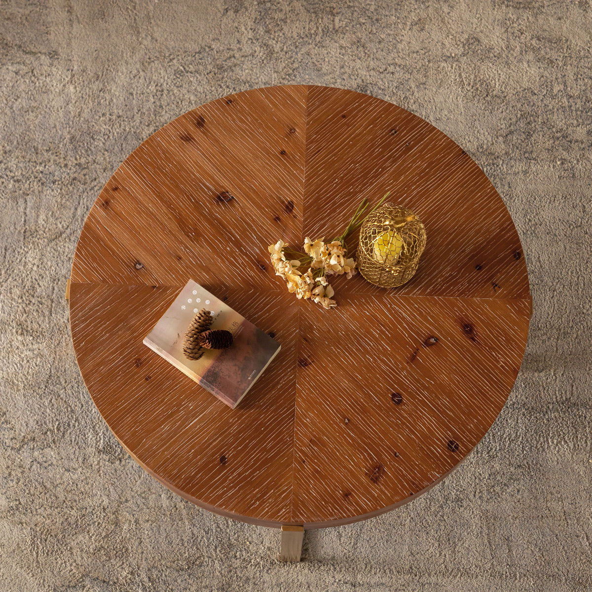 Round fir wood coffee table with circular tabletop and gold-toned base legs